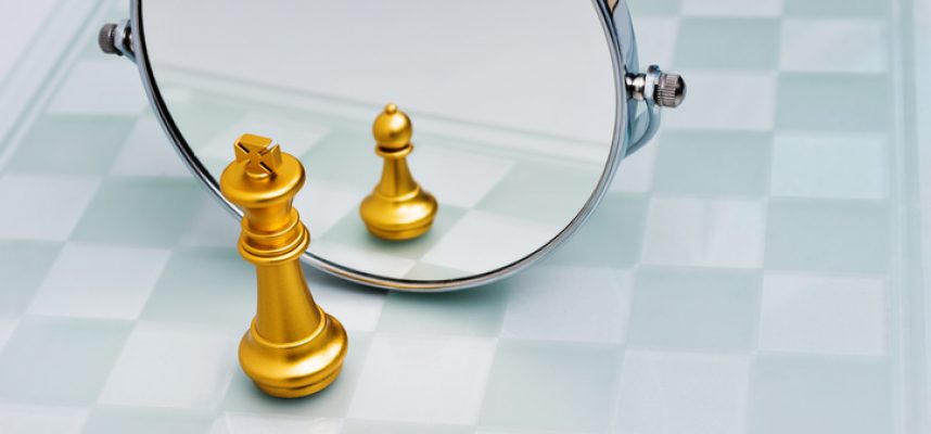 Golden chess king imagining itself as a pawn